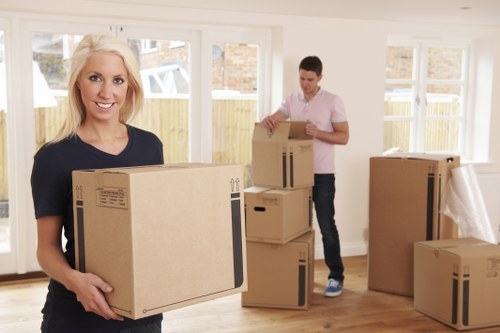 Business relocation team handling office furniture and packing supplies
