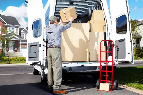 Professional movers loading items into a van in Shepherdsbush