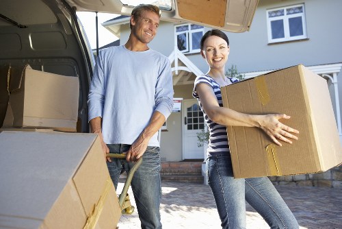 Professional movers loading furniture into a van in Shepherdsbush