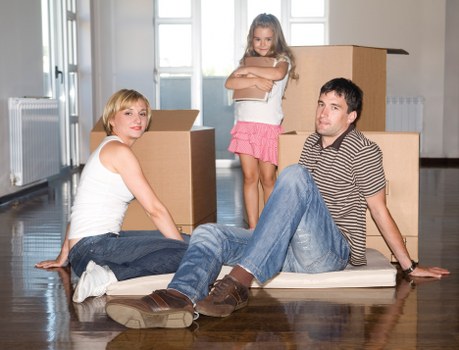 Removalists handling boxes and furniture in a Shepherdsbush home